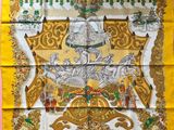 a yellow silk scarf with a picture of a man on a horse