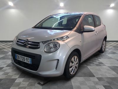 a picture of a small silver car on a checkered floor
