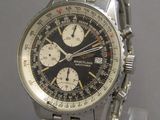 a close up of a wrist watch on a clear stand