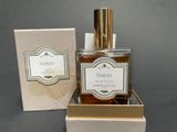 an image of a bottle of perfume sitting on top of a box