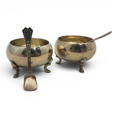 pair of silver plated bowls with spoons and spoon rest