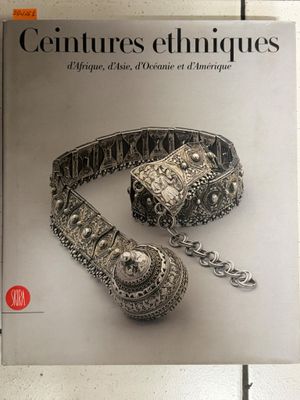 the cover of the book features a silver bracelet and a chain