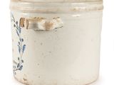 a white container with blue flowers on it on a white surface