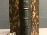 a small book with a bookmark on top of it