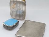 two silver and blue cases sitting next to each other on a white surface