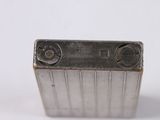 a close up of a metal object on a white surface