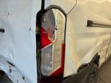 a white van that has been vandalized and is parked in a garage