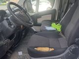 an image of a van with a broken seat and steering wheel