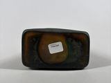 a close up of a black and brown glass object on a white surface