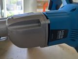 a drill that is sitting on a table next to a window