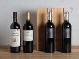 three bottles of wine are lined up on a table next to a wooden box