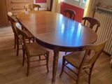 a table and chairs in a room with a radiator in the background