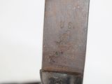 a close up of a knife on a table with a white background