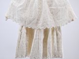 an image of a white dress hanging from a black hanger