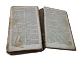 two open books sitting on top of each other on a table