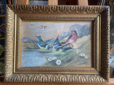 a picture of a painting of birds in a frame on a easel
