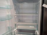 an open refrigerator with a lot of glass shelves