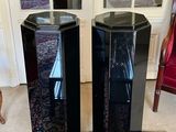 two speakers that are sitting on a rug in a room