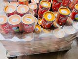 many cans of food on a cart in the store