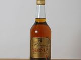 an image of a bottle of liquor sitting on top of a wooden table