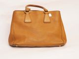 an image of a brown leather handbag on a white background
