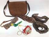 a brown purse and some other items on a white surface