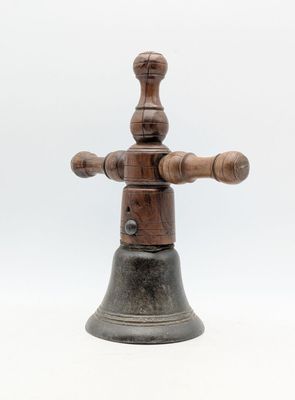 an old wooden bell with a wooden handle on a white background