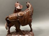 bronze statue of a man on a horse with a hat on