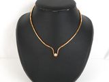 a close up of a necklace on a mannequin with a white background