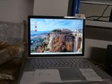a laptop computer sitting on a desk with a mountain view on the screen