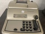 an old typewriter sitting on a table in a room