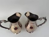 pair of antique silver plated creamer and sugar shakers