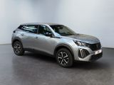 a silver suv parked in front of a white wall