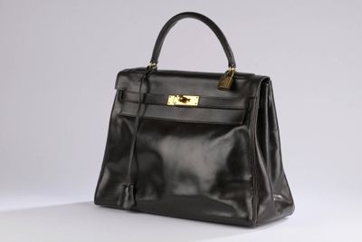 a black leather handbag on a white background