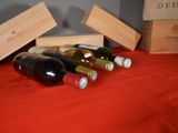 several bottles of wine are lined up on a red cloth