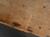 a close up of a wooden table with a piece of wood sticking out of it