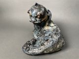 a statue of a dog sitting on the ground