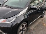 the toyota prius is parked in a parking lot next to other cars