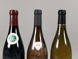 three bottles of wine sitting next to each other on a table
