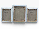 three small wooden frames with writing on them on a white surface