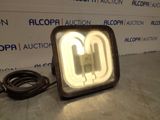 a light that is sitting on a table in front of a wall