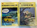two books on a white table with a yellow car and a yellow car