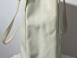 a white purse sitting on top of a white table