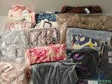 many bags of clothes and bags of clothes on a shelf