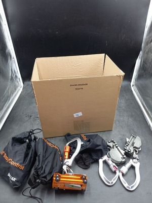 a box of tools sitting on the floor next to a pair of clamps
