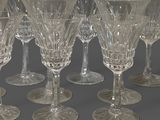 six wine glasses are lined up in a row on a gray surface