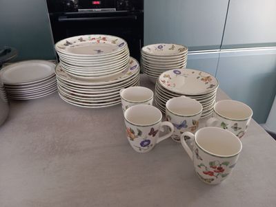 a lot of plates and cups sitting on the counter