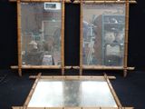 une paire de cadres de miroir en bambou, avec les miroirs en place, sur fond noir