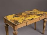 an old wooden table with a yellow marble top and legs