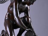 an image of a statue of an angel kneeling on a marble base